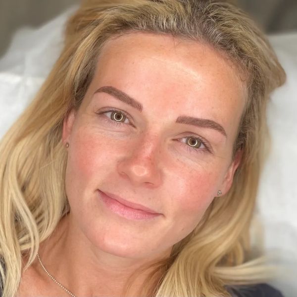 a person smiling with an make up
