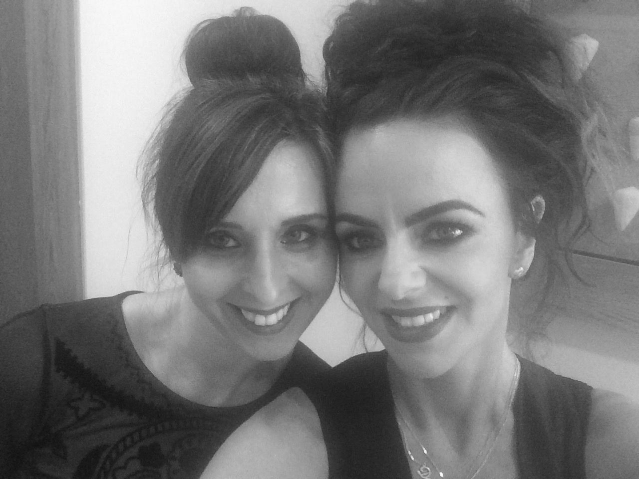 two people smiling at the camera