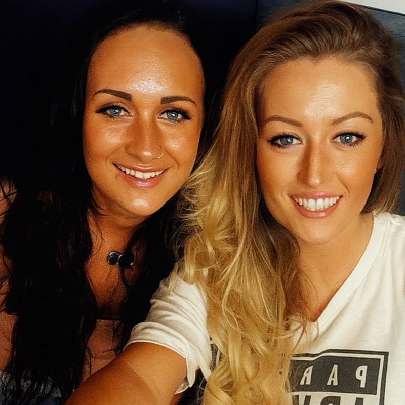 two people smiling at the camera